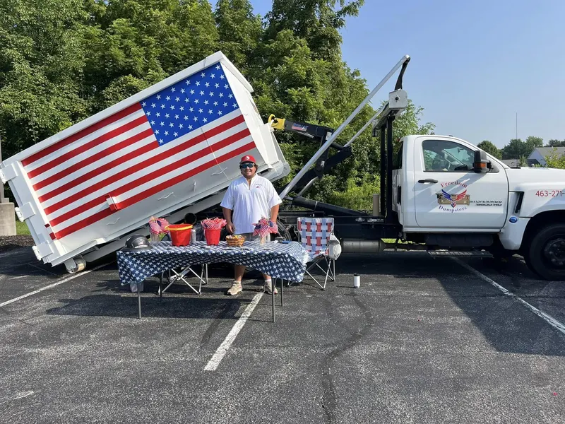 Freedom Junk Removal truck with its American flag dumpster